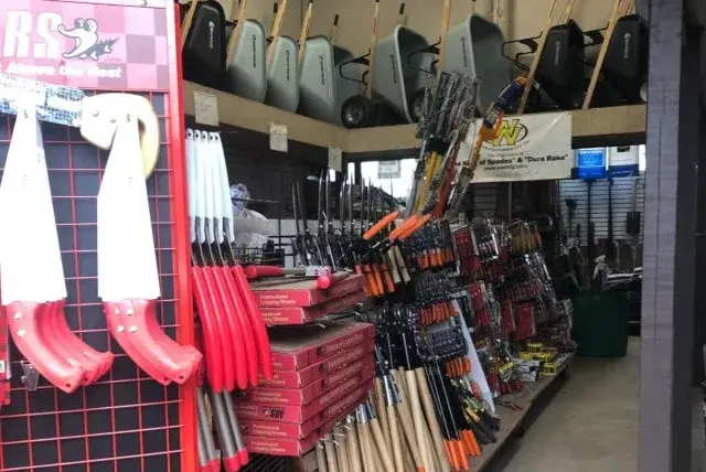 Tidbury Creek Farm's supply store with gardening tools and wheelbarrows.